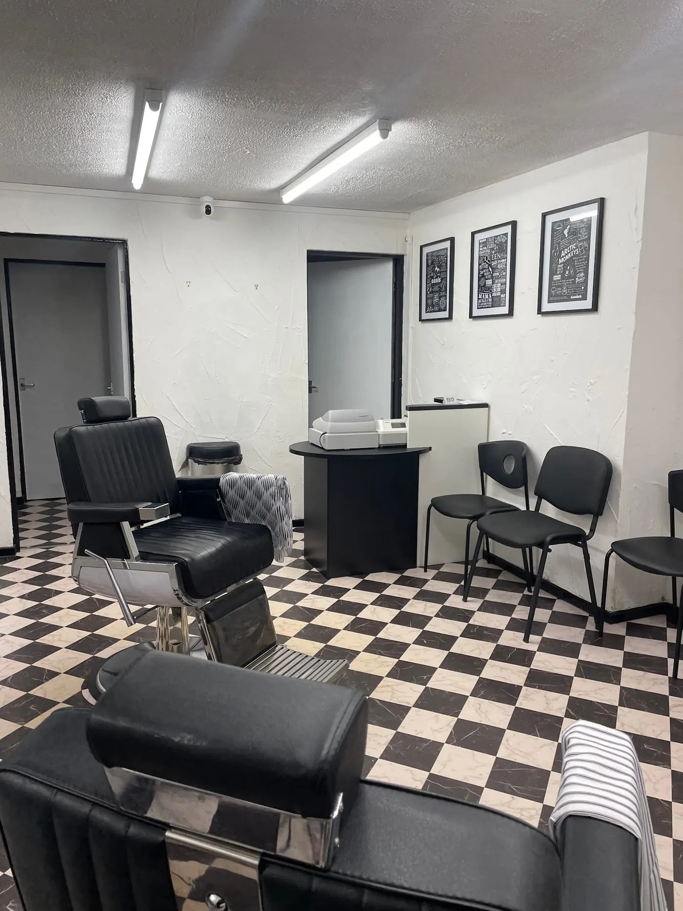 Barber chairs on the black and white checkerboard floor